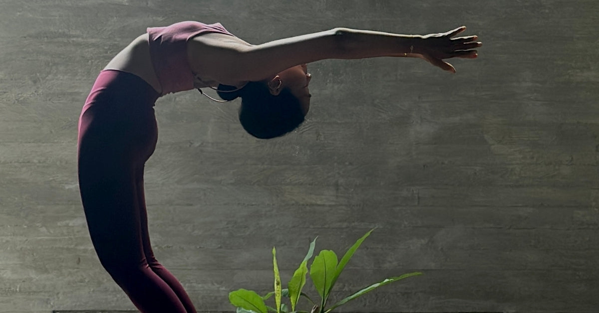 An elegant lady ashtangi in a yoga pose in a beautiful yoga shala in Bali canggu