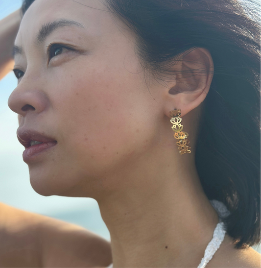 Close up of Asian lady who wears lotus gold adjustable hoops flowers