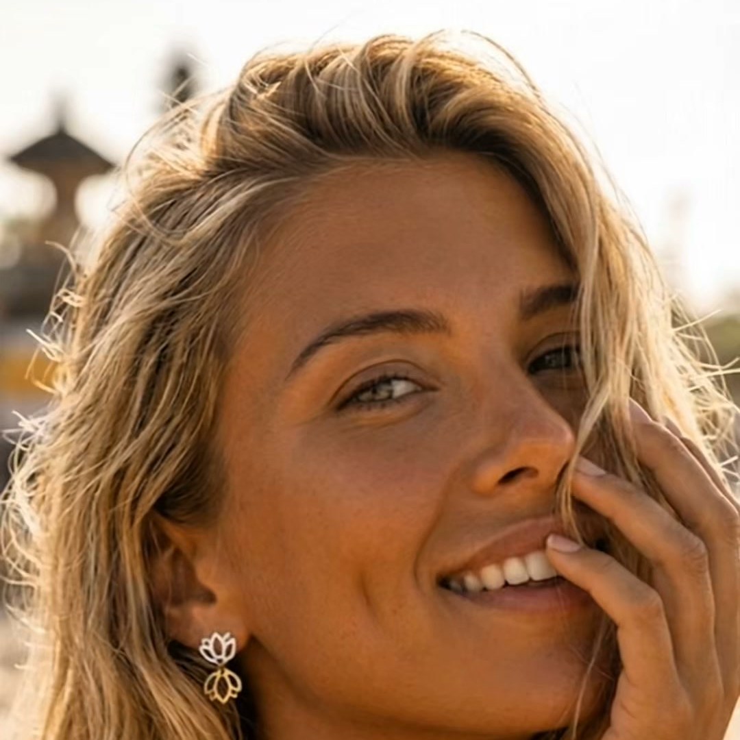 Blonde wearer showing Butterfly double-lotus studs