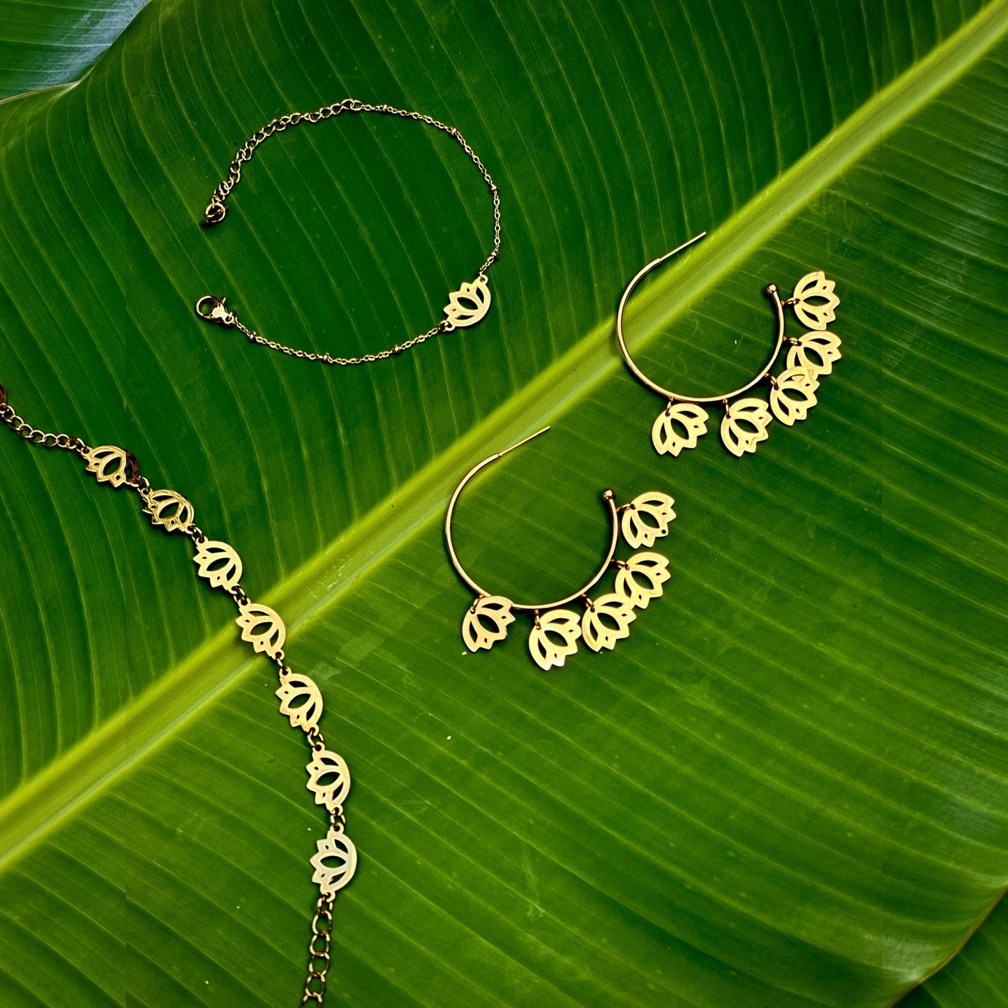 Ekam lotus bracelet and Padma linked-lotus bracelet on green leaves