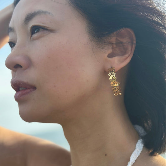 Close up of Asian lady who wears lotus gold adjustable hoops flowers
